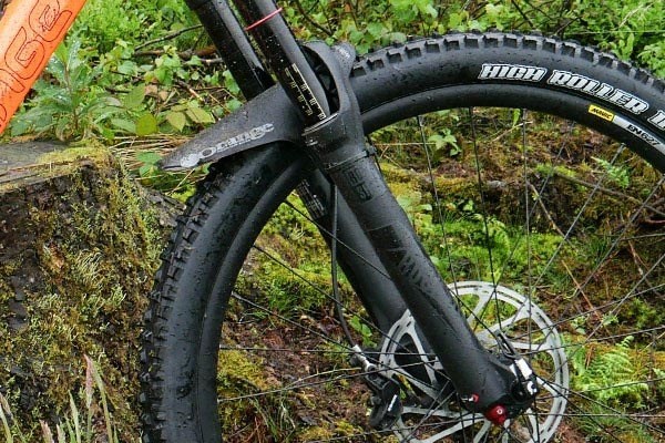 Close up side view of the Orange Five Front wheel, mudguard, and suspension fork. 